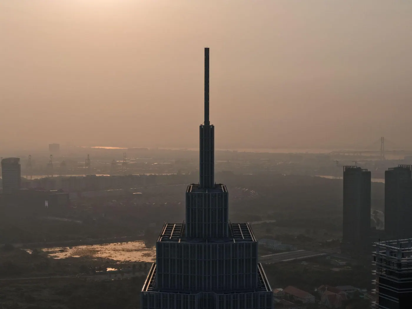 The Empire State Building rising out of the haze at sunrise