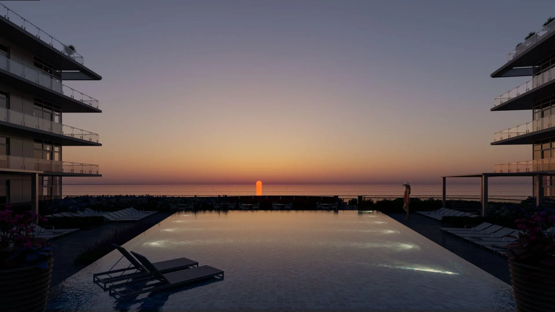 An infinity pool lined up with the setting sun