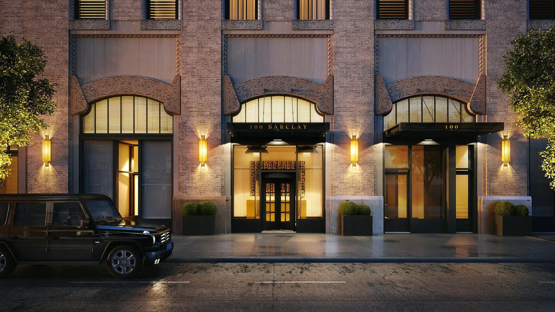 The arched residential entrance of 100 Barclay at night