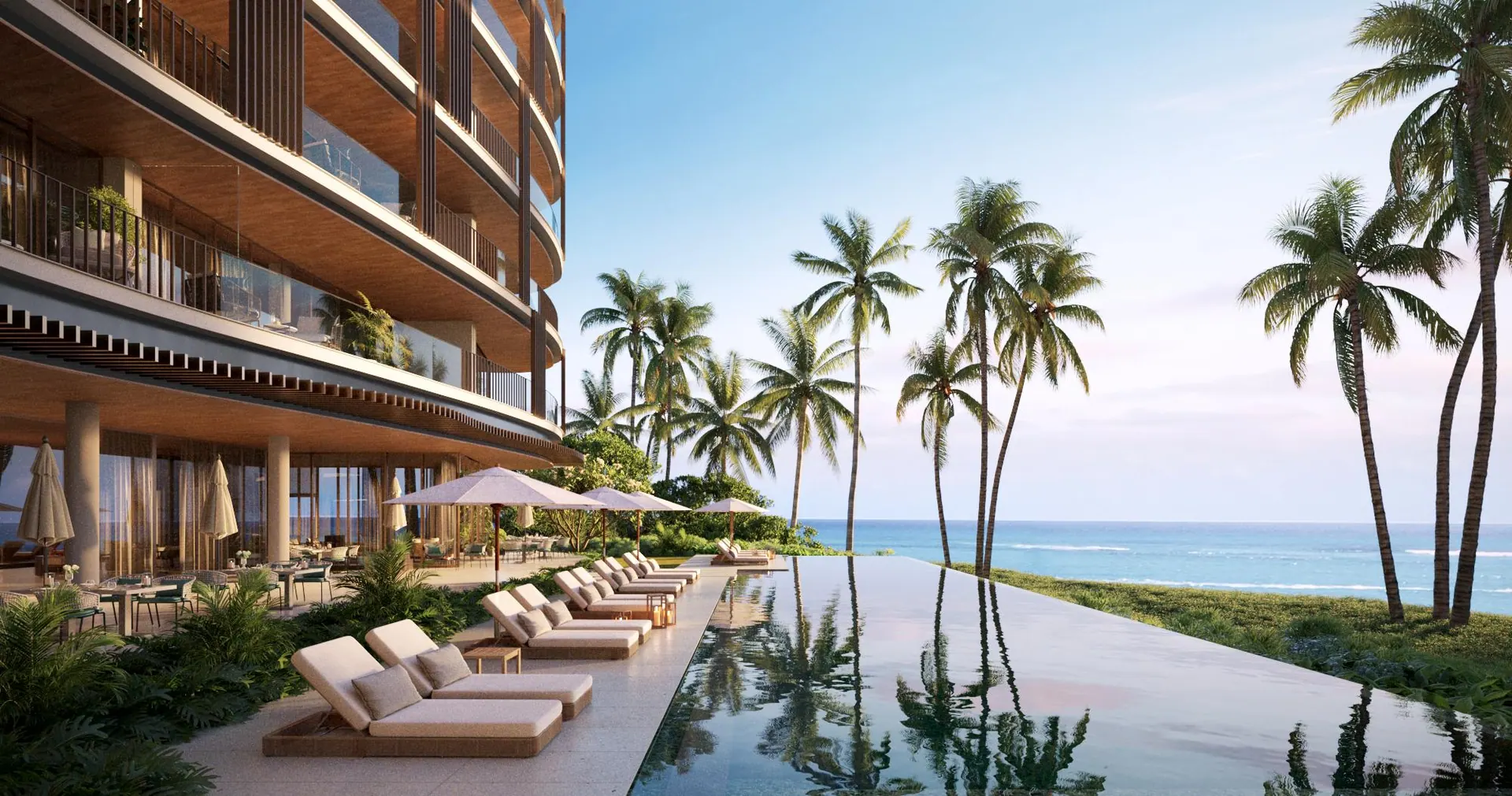 A palm-lined infinity pool facing the Caribbean