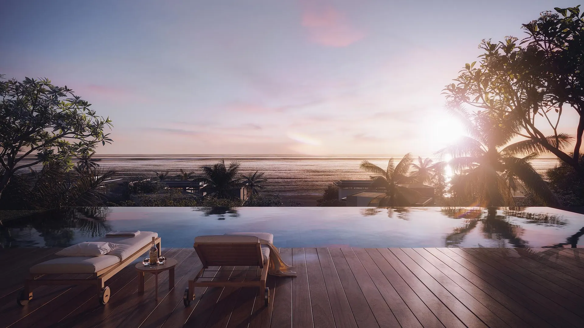 A pool deck facing the sea at sunset