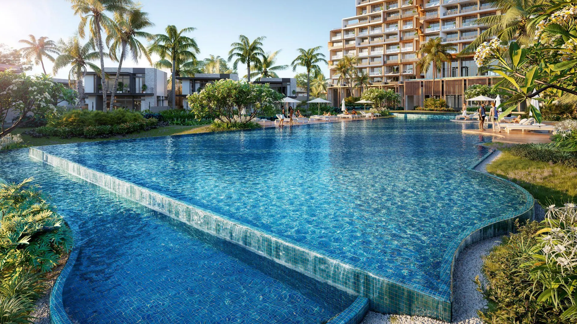A lagoon pool winding between villas and the hotel