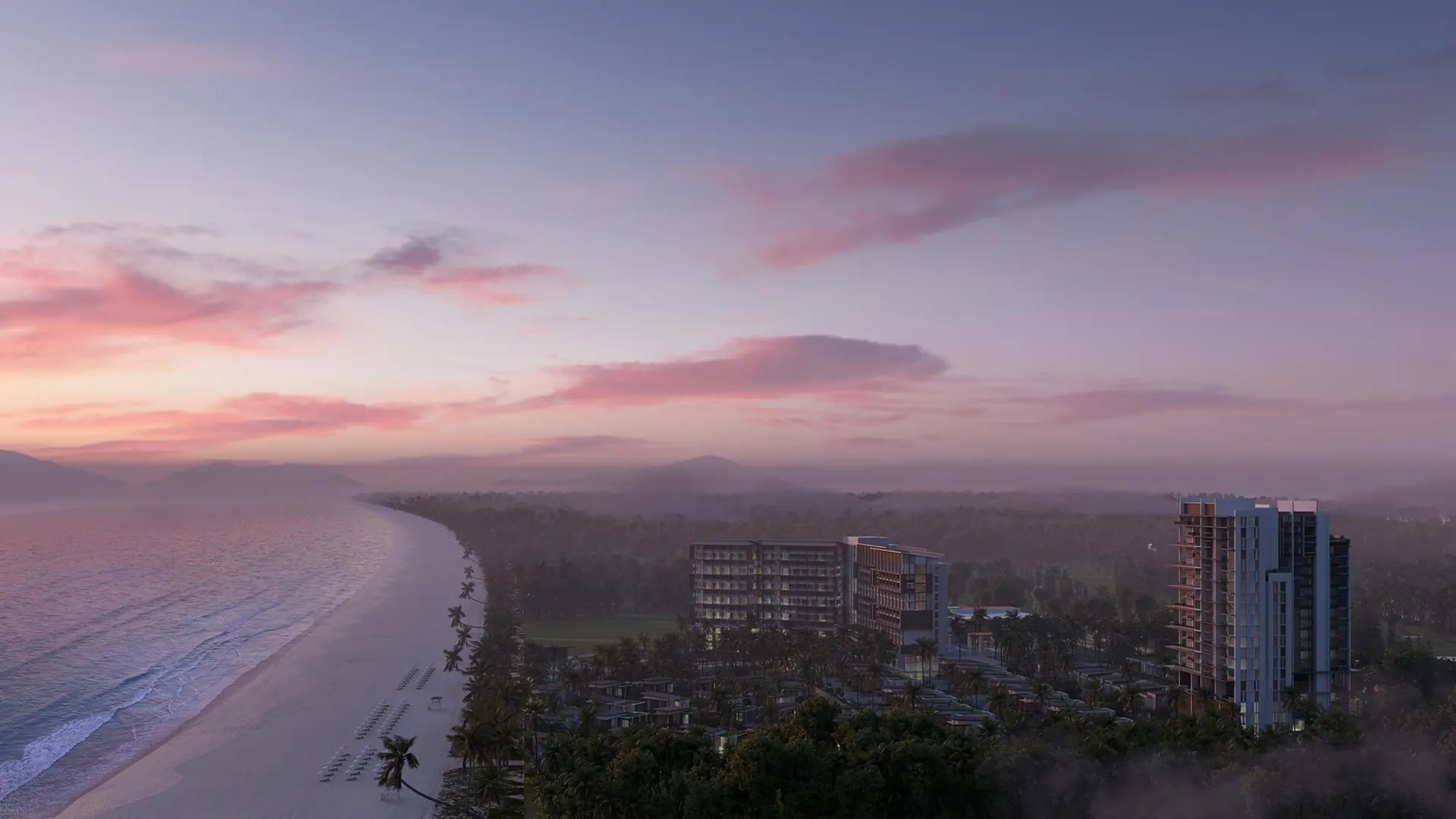 The coast at dusk with the apartment towers lit