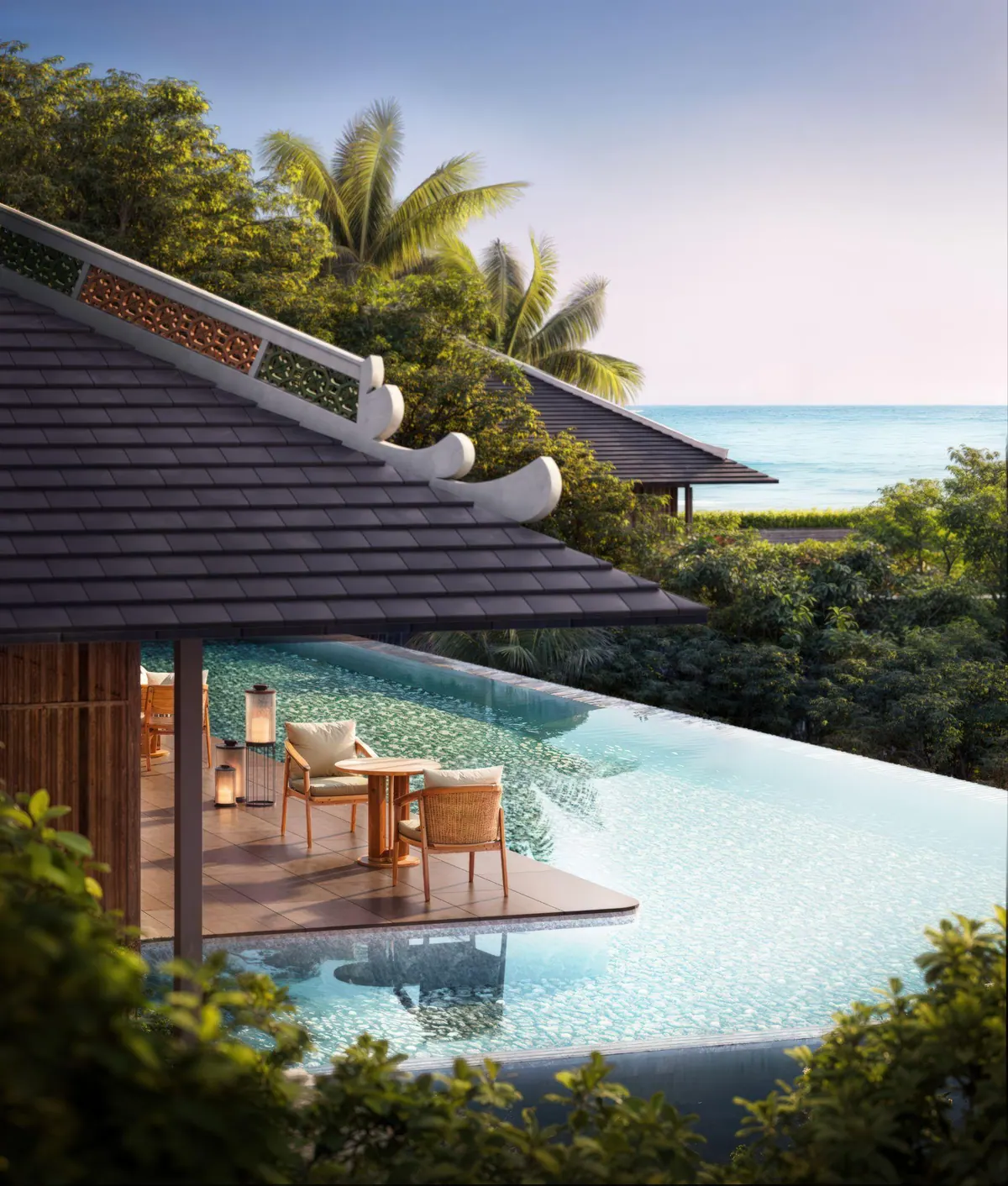 A villa pool under a deep timber roof