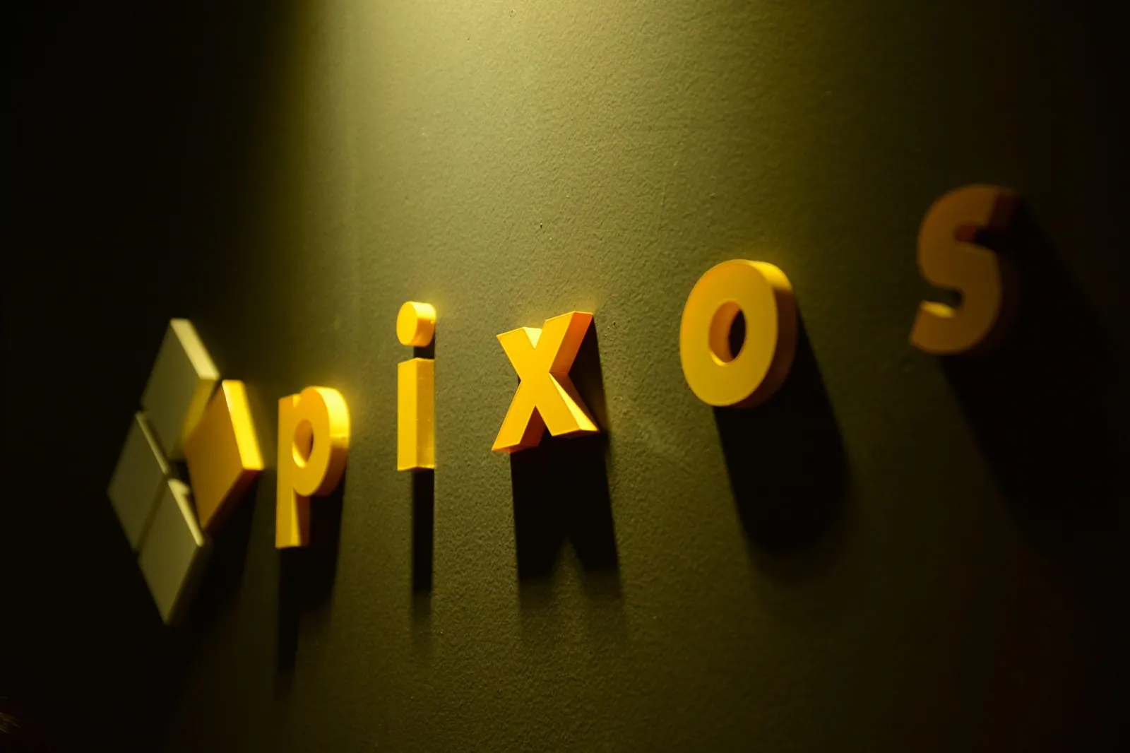 The illuminated 4pixos sign on the studio wall