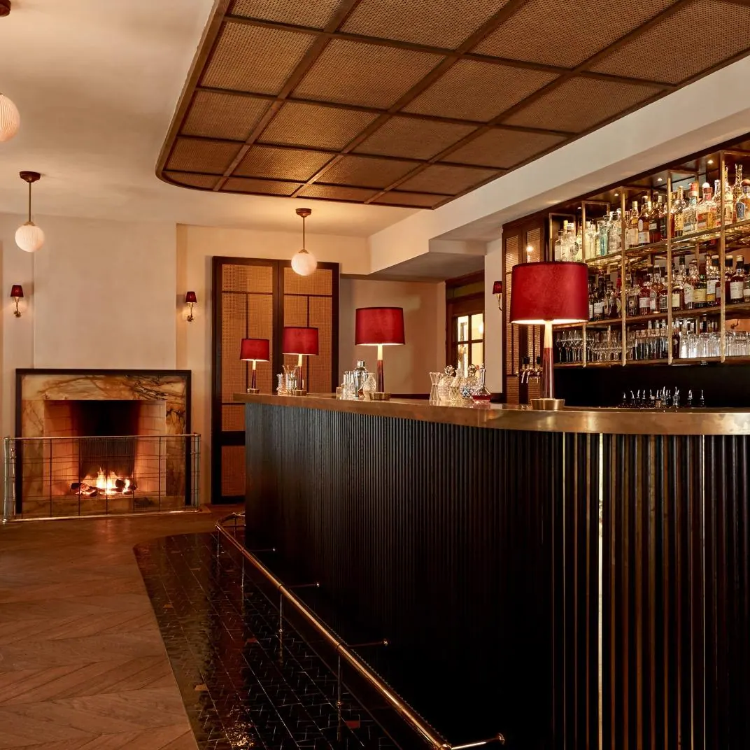 The Hotel Sanders bar beside a fireplace